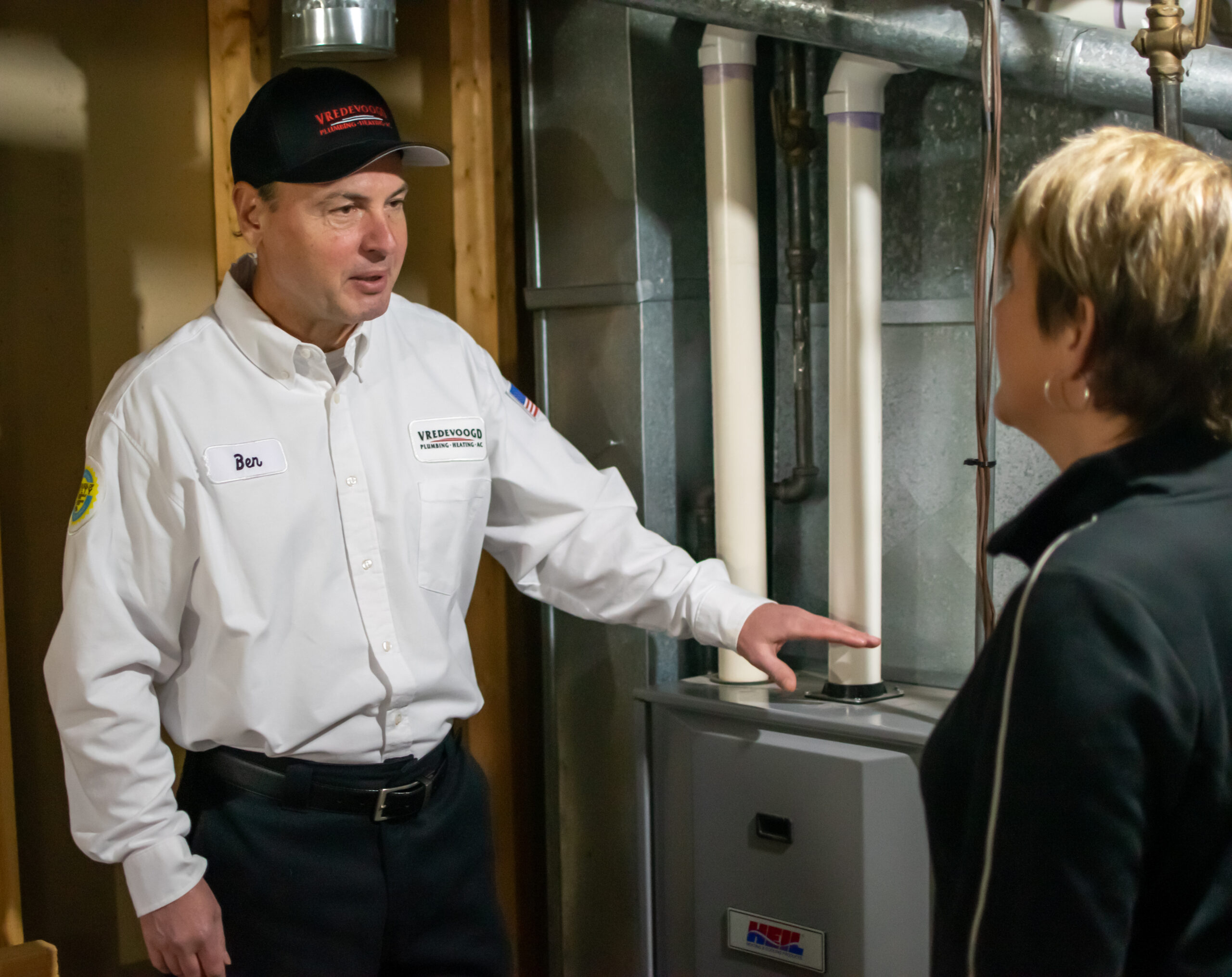 Vredevoogd technician speaking with a homeowner about their furnace