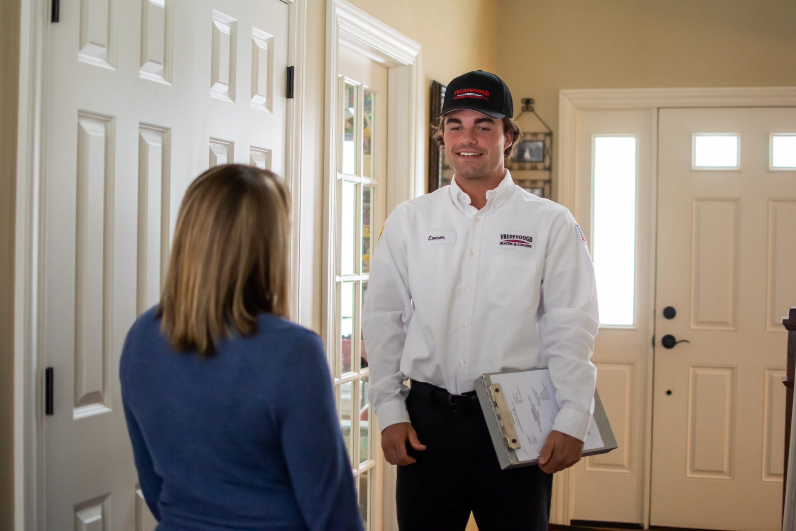 Vredevoogd technician speaking to a homeowner during a service appointment