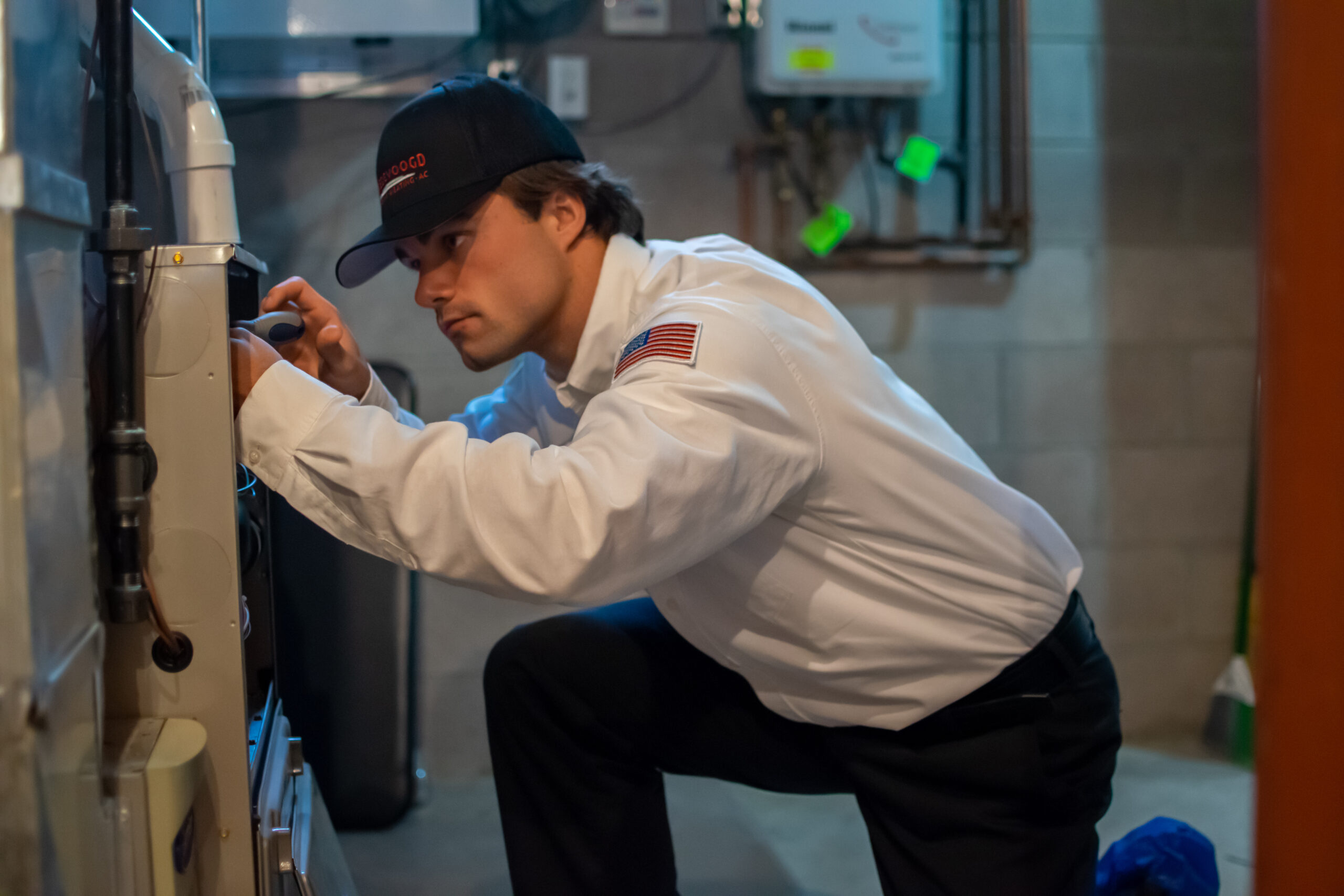 Vredevoogd technician performing a repair service on a home’s furnace