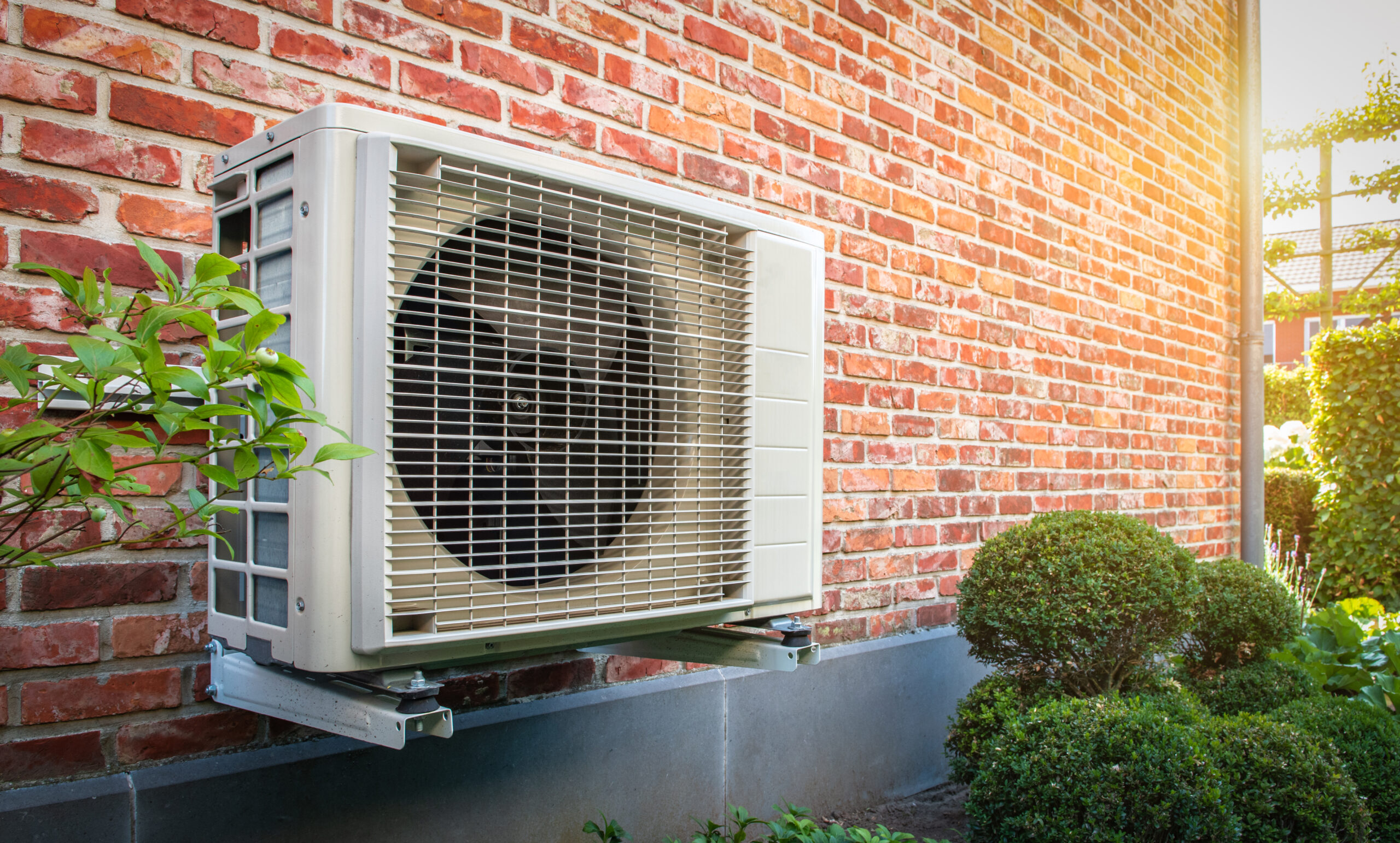 Newly installed heat pump mounted on home’s brick wall