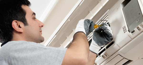 HVAC technician installing a residential ductless AC system