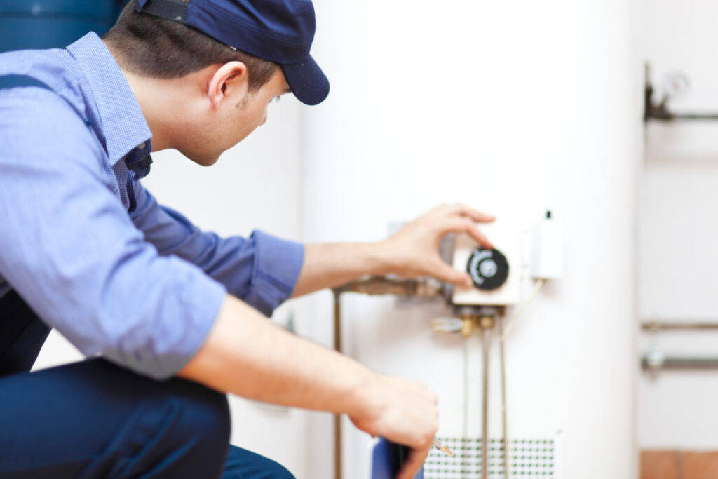 Technician checking on a residential water heater after a service appointment